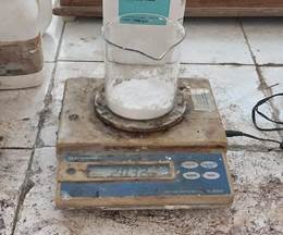 A scale with a beaker and a glass container on it

Description automatically generated