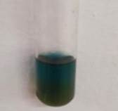 A glass tube with a blue liquid in it

Description automatically generated