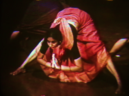 A person in a pink dress bending over

Description automatically generated