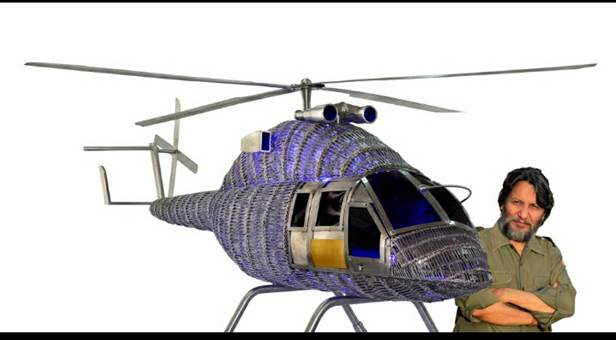 A helicopter model with a person standing next to it

Description automatically generated