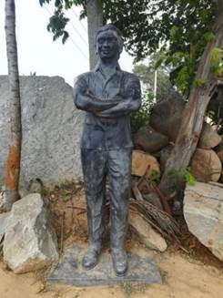 A statue of a person with his arms crossed

Description automatically generated