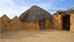 A straw hut in a desert

Description automatically generated